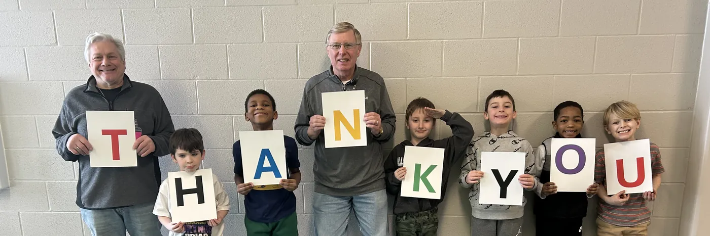 Mentors and students holding up letters that spell THANK YOU